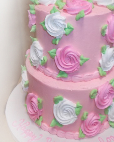 feminine tiered birthday cake decorated in pink and black